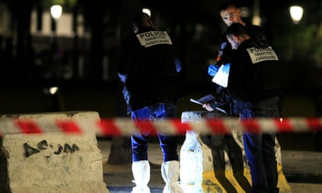Police investigators work at the scene of the attack in Paris