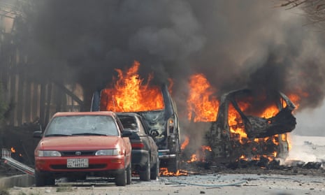 Vehicles burning after a blast near the office of the Save the Children aid agency in Jalalabad.