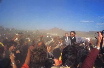 The two men are borne aloft in a large crowd