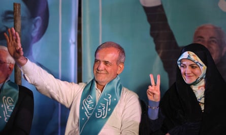Pezeshkian waves as his daughter, wearing a hijab, smiles and gives a V for victory sign
