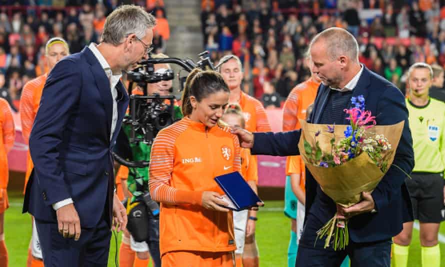 Jan Dirk van der Zee and Nico Jan Hogma of the Dutch Football Association give a presentation to Daniel van de Donk before her 100th appearance for the Netherlands