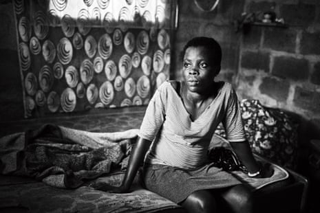 Paulina, 19, sits in the room she shares with other family members in Nyaje village