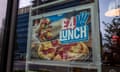 Poster in a window showing a  sliced Domino's pizza with pepperoni and the words "£4 lunch"