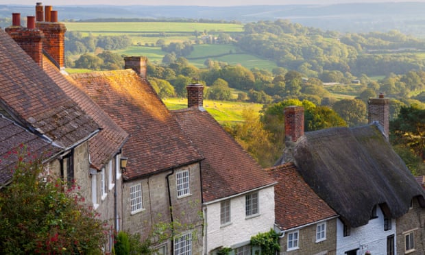 A row of houses with chimneys on a hill in Dorset, England
