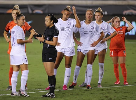Orlando defender Ali Krieger, left, talks to referee Alyssa Nichols during a 2020 match between the Pride and the Houston Dash at BBVA Stadium.