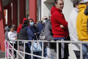 In this March 17, 2020,people wait in line for help with unemployment benefits at the One-Stop Career Center in Las Vegas. A record wave of Nevada residents filed new claims for jobless benefits for a fifth straight, federal officials said, Thursday, April 23, 2020, bringing to more than 343,000 the total since casinos and other businesses were closed in mid-March to prevent spread of the coronavirus.