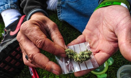 A demonstrator showing cannabis during a protest in front of parliament in London.