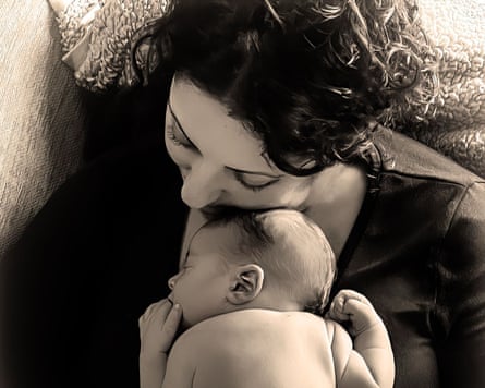 Black and white image of Narzny McKinney cradling baby Zak