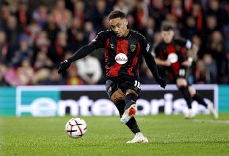 Marcus Tavernier takes a penalty in a black and red striped Bournemouth kit