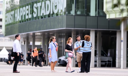 Visitors talk to security staff outside the Ernst Happel stadium in Vienna
