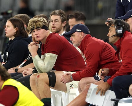 Henry Pollock looks on from the bench after being shown a yellow card