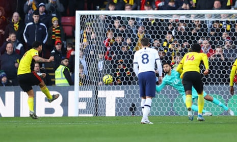 Tottenham’s Paulo Gazzaniga dives to his right to save the penalty from Troy Deeney of Watford