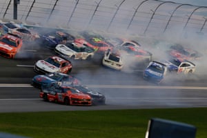 A group of 17 cars, all facing different directions, surrounded by smoke