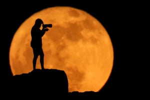 A photographer is silhouetted against the strawberry moon in Arinaga, on the island of Gran Canaria, Spain. This first full moon of June coincides with a rare astronomical phenomenon, the lunistice, in which the star reaches its most extreme inclination within its orbit. It won’t be repeated until 2043
