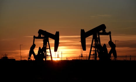 Oil pump jacks silhouetted at dusk in in Texas
