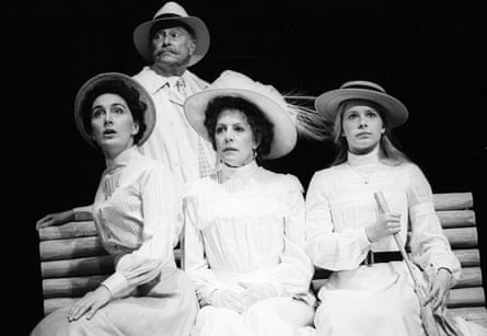 The three women, all dressed in white, sit on a bench with Gaev standing behind them