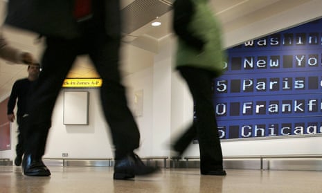 People walking through Heathrow airport.
