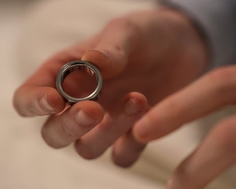 a woman puts on a sleep tracking ring