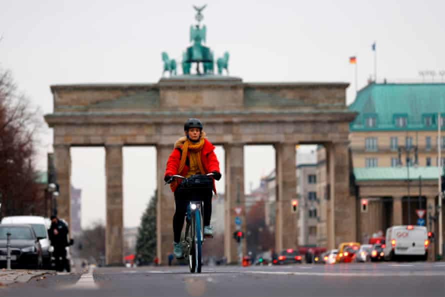 A cyclist is seen on the cycle path along the 17th June boulevard near the landmark Brandenburger Gate in central Berlin.