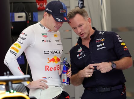 Red Bull team principal Christian Horner (right) and driver Max Verstappen talk in the pits during the qualifying for the 2024 Saudi Arabia GP