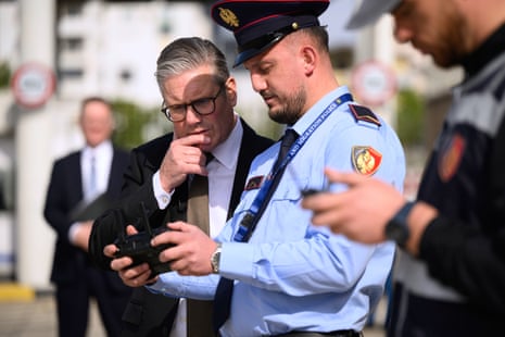 Keir Starmer speaking with a drone operator at the ferry port near Tirana, Albania, today. He was being shown the procedures carried out by search teams as they check vehicles.