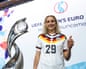 The midfielder Vanessa Diehm poses with the trophy after Germany was named Euro 2029 host nation