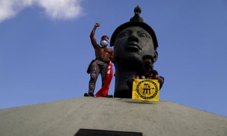 Demonstrators protest against Jair Bolsonaro in front of Monumento Zumbi in Rio de Janeiro