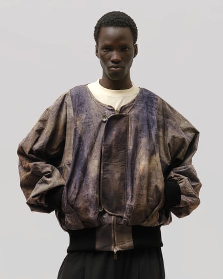 A man wearing a jacket with tie-dyed style print