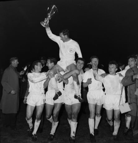 Danny Blanchflower is carried by his Tottenham teammates while holding the European Cup Winers’ Cup trophy aloft