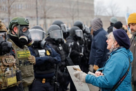 Protesters clash with federal agents outside the Whipple Federal building in Minneapolis. The demonstration is in response to the murder of Renee Good by federal immigration agents last week.