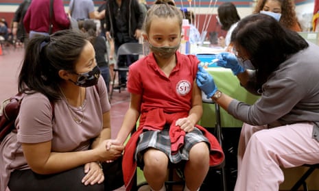 Adeline Fahey, 6, receives a child's dose of the Pfizer vaccination in Los Angeles.