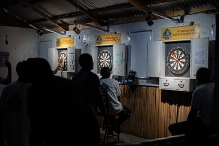 Members of Oche Addicts play darts.