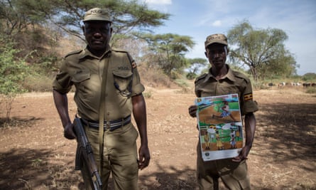 Ugandan police display a poster warning girls not to cross the border to Kenya to undergo female genital mutilation
