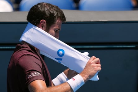 Karen Khachanov wraps an ice towel around his neck during a break in his third round match against Luciano Darderi.
