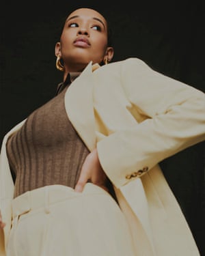 Pastel yellow blazer, £270, and trousers, £140, by Remain, and brown ribbed polo neck, £265, by Totême, all from brownsfashion.com. Open toe mules, £260, by MAXINE x &Finally from maxineshoes.com. Chunky gold earrings, £110, mishodesigns.com