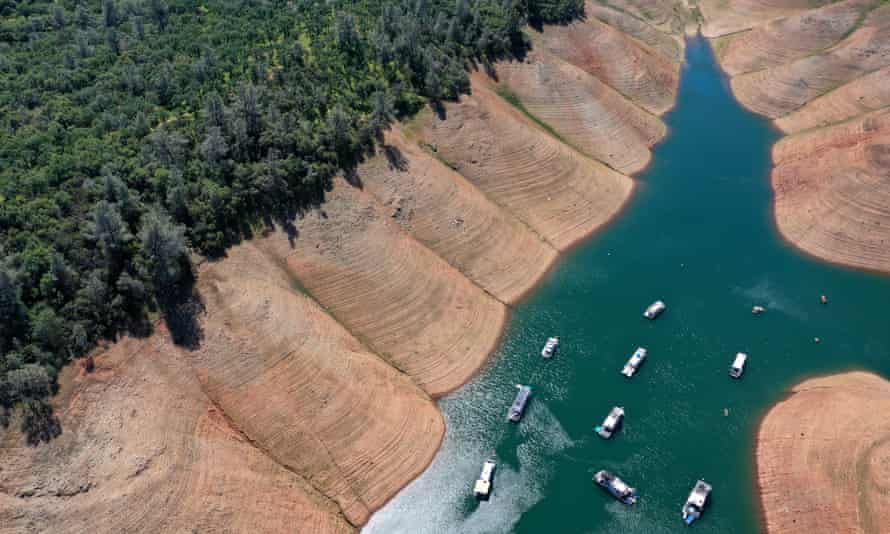 Houseboats are dwarfed by the steep banks of Lake Oroville last month in Oroville, California.