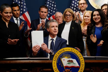 a seated man holds up a document flanked by several other people
