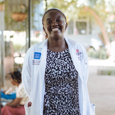 Chikondi Chiweza wearing a white doctorâs coat and smiling