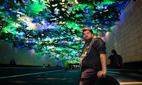 Benjamin Austin beneath Flight Path, a sculptural tree canopy that covers the walkway between concourses A and B.