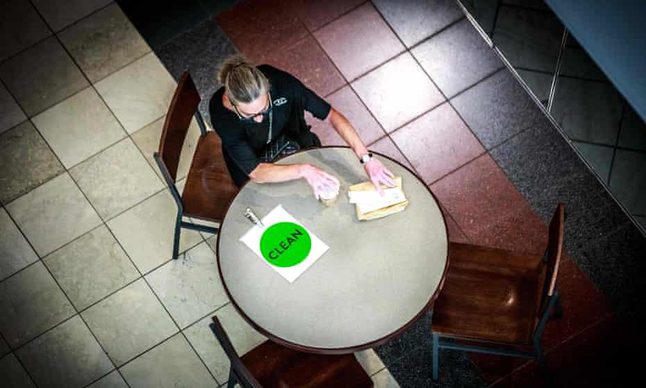 A woman sits at a table with a sign reading ‘clean’ at the Mall of America in Bloomington, Minnesota.