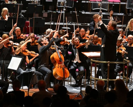 Guy Johnston and the string section of the BBCSO hold their bows in the air, conducted by Sakari Oramo, at the Royal Albert Hall