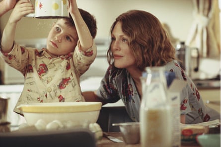 Laura Brown watch as a small boy sifts flour in a family kitchen