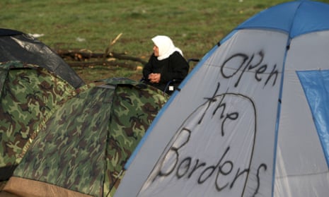 A woman sits in a tent camp near Idomeni on 1 March, 2016 at the Greek-Macedonian border.
