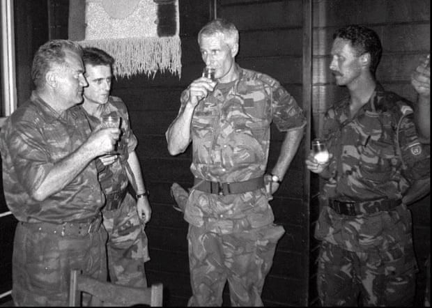 General Ratko Mladić of the Bosnian Serb army, left, drinks with Dutch colonel Ton Karremans, second right, in the Bosnian village of Potocari, on 12 July 1995.