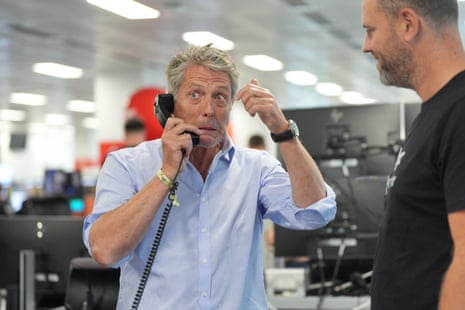 Hugh Grant on the phone during the BGC annual charity day at their offices in Canary Wharf, London.