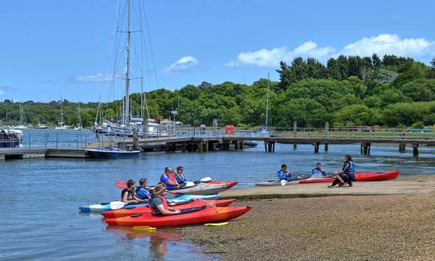 People on a kayaking lesson on Beaulieu River at Buckler’s Hard Maritime Museum, New Forest, Hampshire, UK