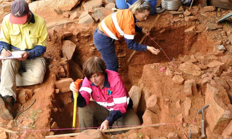 Jo McDonald, centre, excavating at a Murujuga rock shelter in Western Australia. Artefacts uncovered in the past year show human occupation dating back 21,000 years.