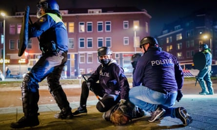Police officers arrest a man during clashes in Beijerlandselaan.