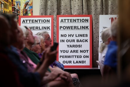 A sign reads “Attention powerlink. No HV lines in our back yards! You are not permitted on our land!”