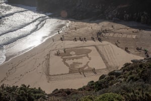 A large scale portrait of Lt Richard Charles Graves-Sawle, one of a number from the project called Pages of the Sea. Porthcurno beach was among 32 other beaches around the country taking part in the first world war commemoration hosted by film director Danny Boyle. The portraits represent a range of interesting stories of ordinary people who gave their lives. See more from Armistice Day around the world here